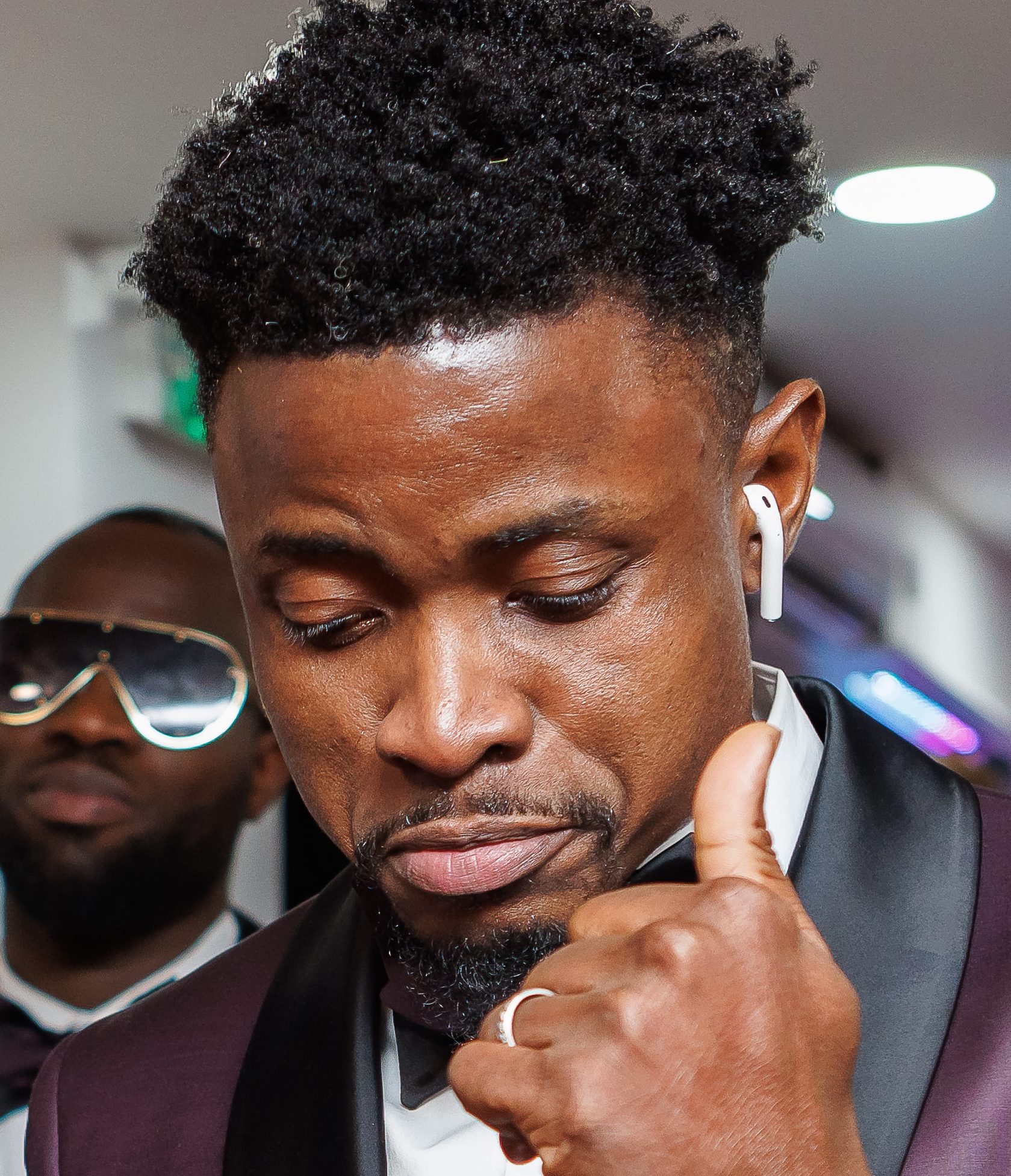 Nigerian Wedding DJ London groomsman wearing a apple airpod and dancing